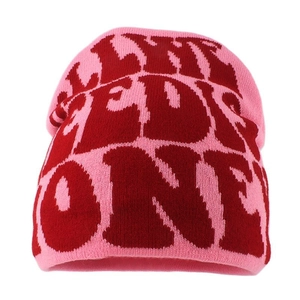 Pink knit beanie hat featuring large red REDS ONE lettering for winter warmth
