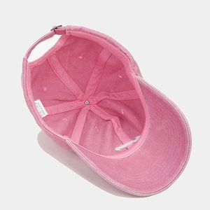 Close-up of the inner structure and metal buckle of a vintage pink cotton baseball cap