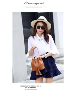 Chic brown PU leather bucket bag with fringe tassels styled with a summer outfit
