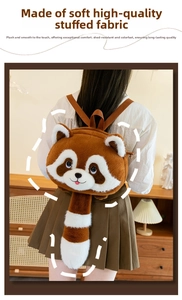 Close-up of soft plush red panda bag featuring a long striped tail and fluffy texture