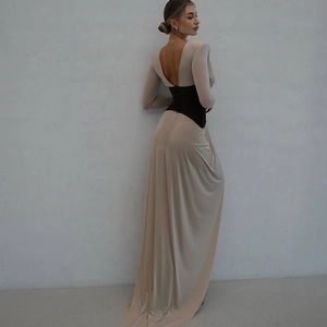 Macro view of a backless beige maxi dress with V-back and black waist panel design