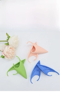 Detailed view of soft latex elf ears in pink green and blue for cosplay parties