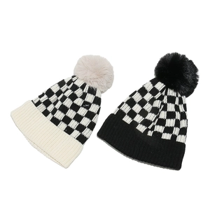 Women's knit beanie with checkerboard pattern and faux fur pom pom in two colors