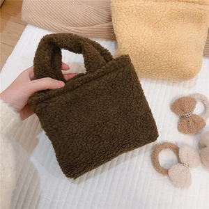 Gros plan du mini sac à main en polaire marron foncé avec texture douce en peluche