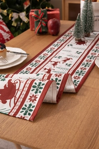 Detailed view of linen blend Christmas table runner with red reindeer and snowflake prints