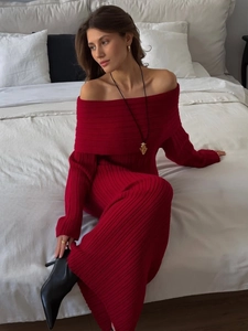 Detail of red off-the-shoulder knit dress showing ribbed texture and elegant fit