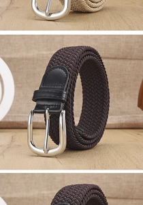 Detail of woven elastic canvas belt with leather trim and silver metal pin buckle