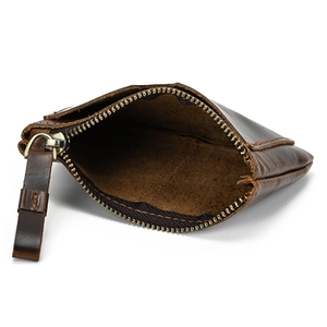Detailed interior of dark brown genuine leather coin purse with brass zipper and leather pull