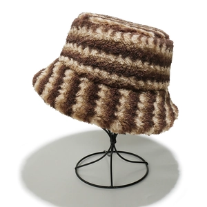 Close-up of plush striped bucket hat with brown and beige faux fur texture details