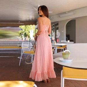 Pink two-piece summer set with bow strap crop top and pleated high waist maxi skirt