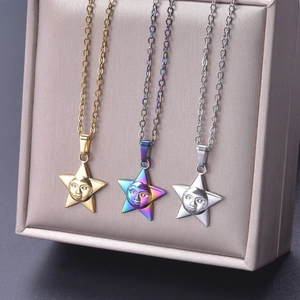 Three celestial star necklaces in gold, rainbow, and silver displayed on a jewelry box