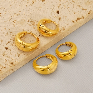 Polished 18k gold plated 18mm stainless steel thick hoop earrings on stone background