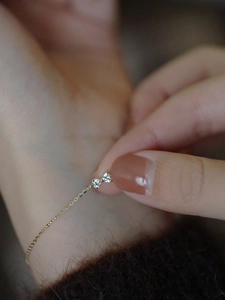 Close-up of S925 silver bow bracelet with heart zircon and 14k gold plating details