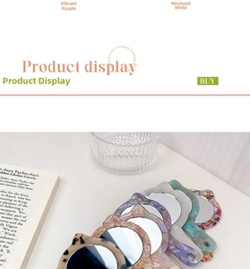 Close-up of cat-ear handheld mirrors with colorful marbled acetate frames on a table