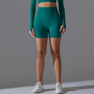 Detail of high-waist peach lift yoga shorts in turquoise seamless knit fabric