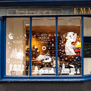 Stickers de fenêtre de Noël blancs avec Père Noël et renne sur une vitrine cosy