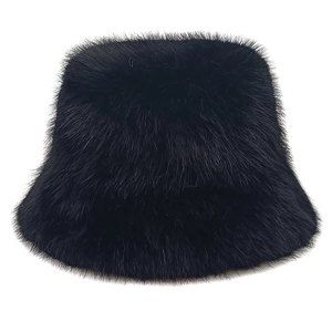 Close-up of fluffy black faux fur fabric texture on a warm winter bucket hat