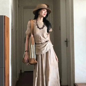 Detail of bohemian wood bead circular necklace paired with a beige linen dress set