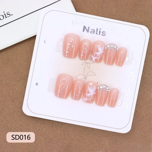 Handmade press-on nails with peach pink butterfly floral designs and sparkling rhinestones