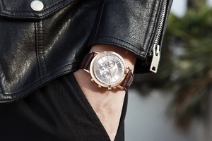 Close-up of Kademan rose gold three-eye watch on wrist with brown leather strap