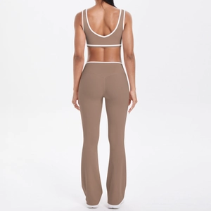 Rear view detail of two-piece yoga set featuring brown flared pants and contrast white piping