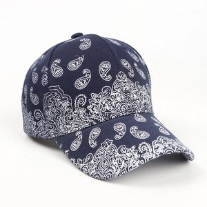 Side view of dark blue paisley baseball cap with detailed cotton embroidery and firm peak