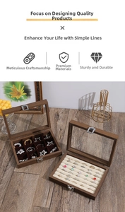 Detail view of walnut wood jewelry box with glass lid and multiple storage compartments