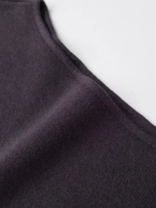 Detailed macro view of dark grey knitted fabric texture and premium hem finish