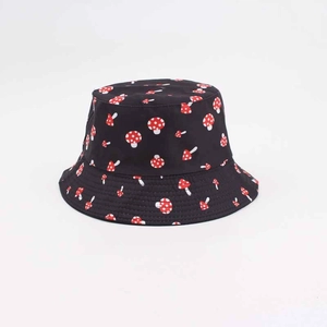 Close-up of black reversible bucket hat with red and white polka dot mushroom print