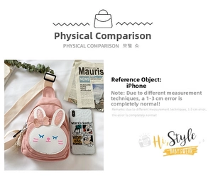 Pink canvas kids fanny pack with rabbit design and fringe detail shown with phone for scale