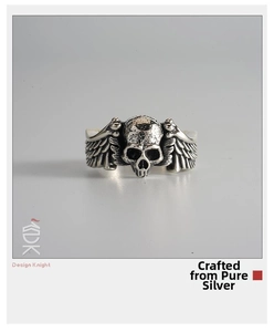 Detailed macro view of the punk skull and silver wings engraving on a sterling silver ring