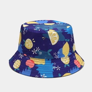 Detailed view of dark blue bucket hat with yellow lemon and pink fruit print texture