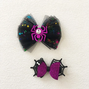 Detail of Halloween hair clips with black spider mesh bow and purple glitter cobweb bow