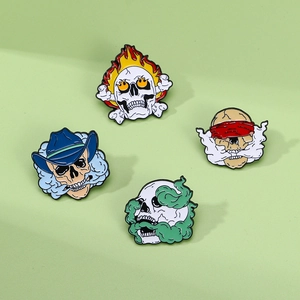 Punk style skull enamel pins set with flame and smoke motifs on light green background