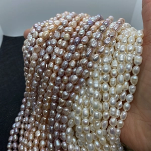 Macro shot of assorted baroque freshwater pearls in white, pink, and purple shades