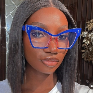 Macro shot of oversized blue cat-eye glasses with silver rivets and transparent lenses