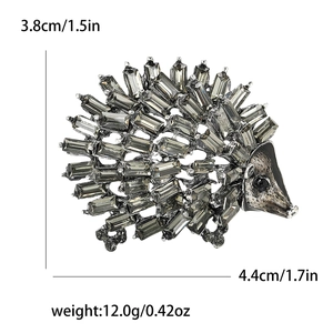 Cartoon hedgehog alloy brooch with gray rhinestones and sizing info on white background