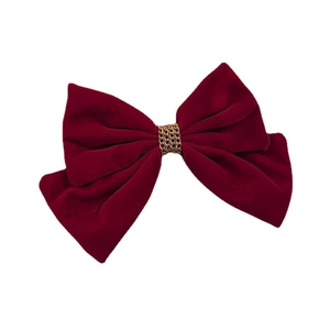 Deep red velvet bow hair clip with gold chain accent on a clean white background