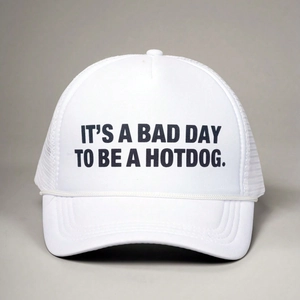 Classic white trucker hat featuring black slogan print and breathable mesh back