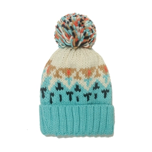 Close-up of geometric jacquard pattern and colorful pompom on blue knitted mohair hat