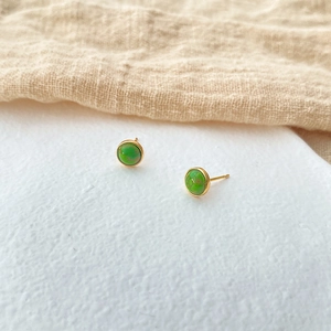 Detail of round green turquoise stud earrings with 18K gold plated brass settings