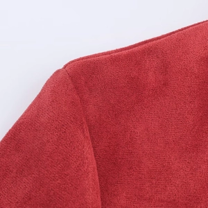 Detailed macro view of the shoulder seam on a red suede finish casual fashion jacket