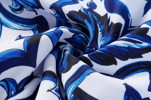 Macro view of blue floral porcelain pattern on smooth backless one-piece swimwear fabric