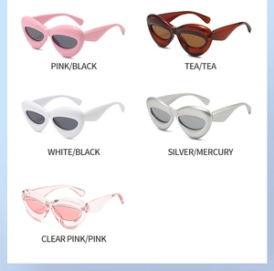 Flat lay of multiple stylish cat-eye sunglasses in various colors like pink, white and silver