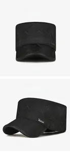 Close-up of black quilted flat top cap with winter ear protection and metal logo detail