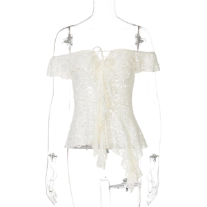 Detail of white lace off-shoulder top with ruffled asymmetric hem and front tie design