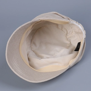 Detail view of the breathable linen duckbill hat interior with sweatband and woven label