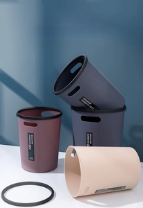 Three minimalist plastic trash cans with press rings and handles in various colors
