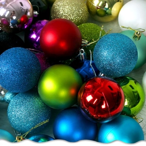 Close-up of assorted Christmas ornaments with matte, glossy, and glitter finishes