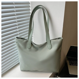 Detailed view of light green nylon tote bag on a window sill for daily commuting